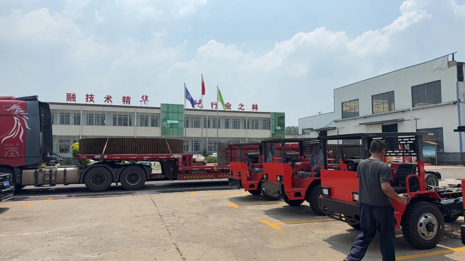Mining vehicles staged in the factory yard.